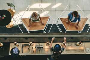 People using rolling table to keep distance at business event