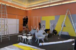 Set carpenters build background panel of mobile live-stream studio