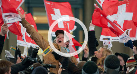 Happy fans with Swiss flags singing