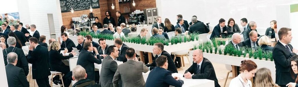 Sales persons at tradeshow booth in engaging talks