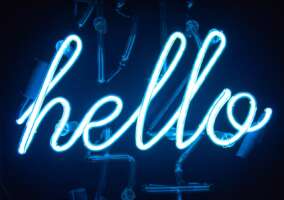 Neon Sign in blue & white writing "Hello"