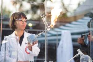 Scientist showing an chemical experiment at outdoor laboratorium